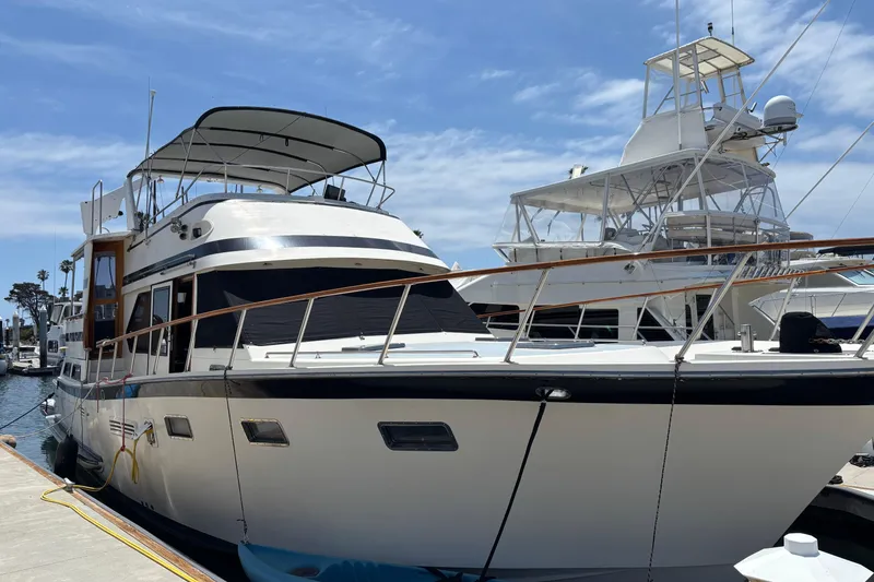 1988 Overseas PT52 Cockpit Motoryacht docked under a clear blue sky.