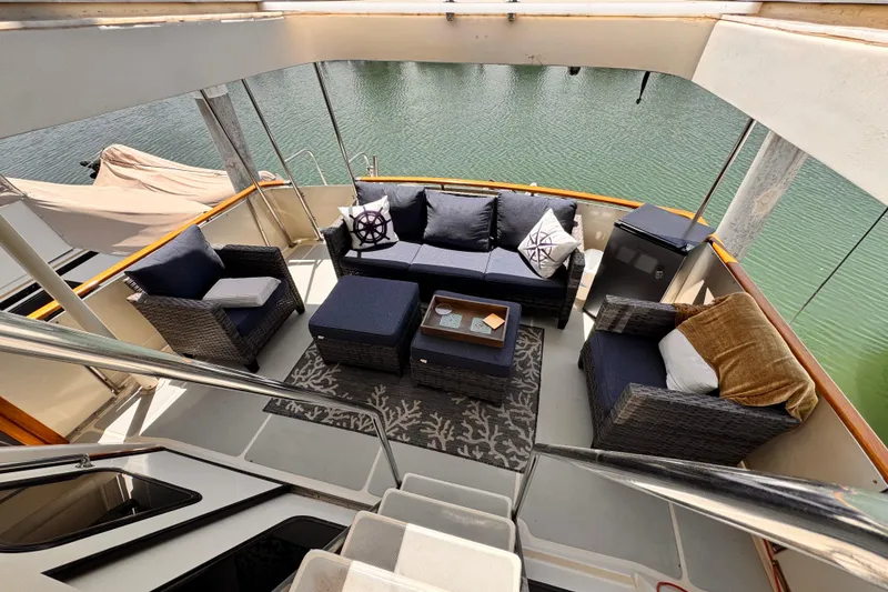 Luxurious 1988 Overseas PT52 cockpit motoryacht with elegant outdoor seating area.