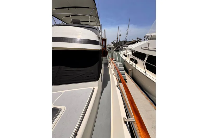 1988 Overseas PT52 Cockpit Motoryacht docked, showcasing sleek design and spacious deck.