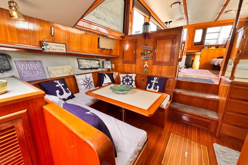 Interior of 1988 Overseas PT52 Cockpit Motoryacht with nautical-themed decor and wooden furnishings.