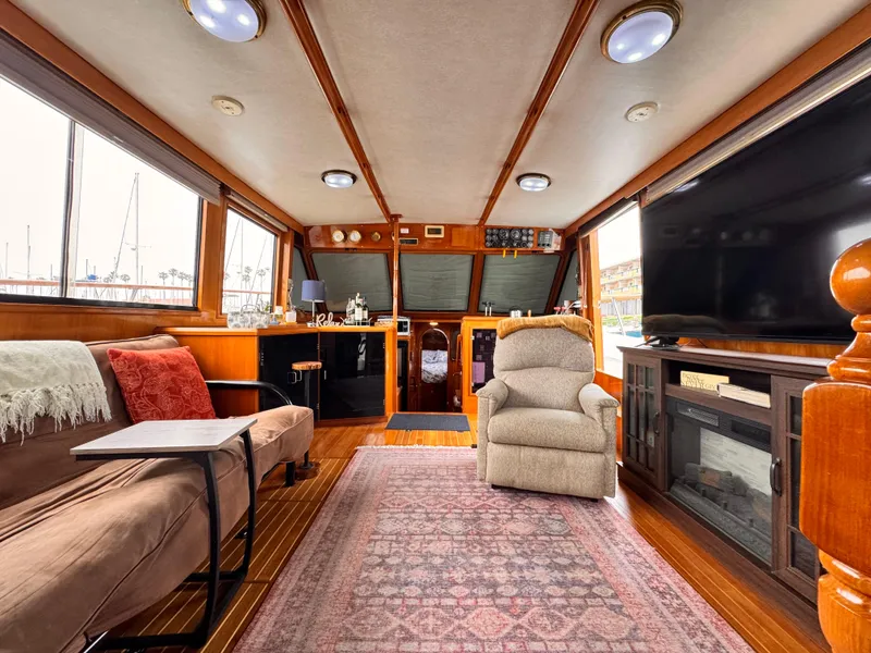 Luxurious 1988 Overseas PT52 Cockpit Motoryacht interior with cozy seating and elegant decor.