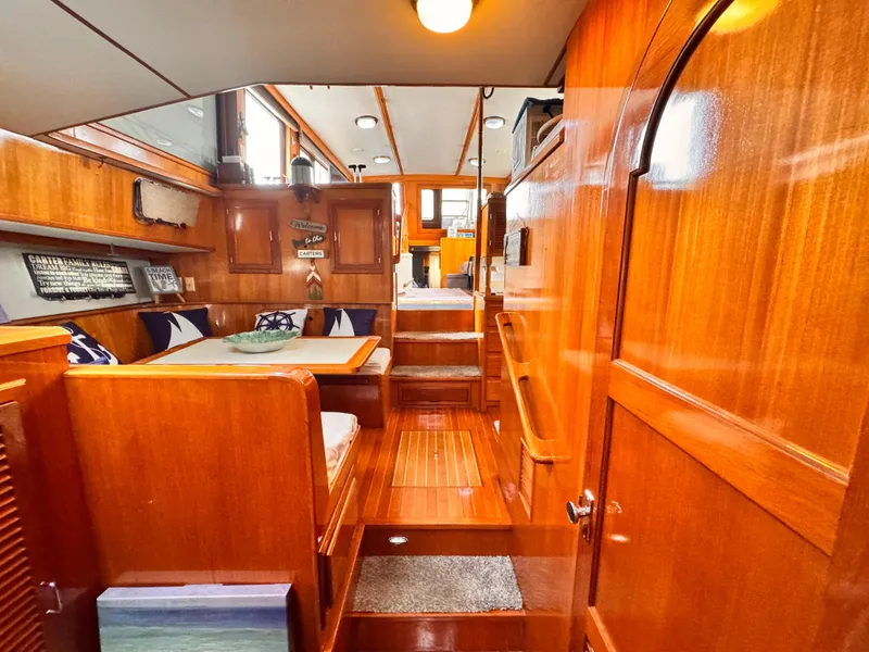 Interior of 1988 Overseas PT52 Cockpit Motoryacht with polished wood and cozy seating area.