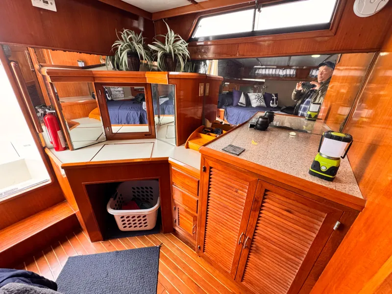 Interior of 1988 Overseas PT52 Cockpit Motoryacht with wood cabinetry and mirrored surfaces.