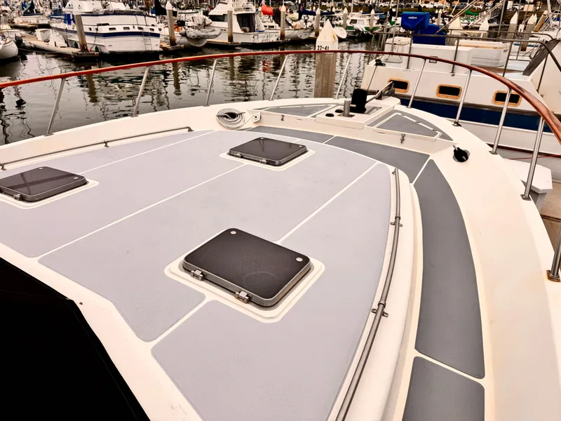 1988 Overseas PT52 Cockpit Motoryacht deck view in marina setting.