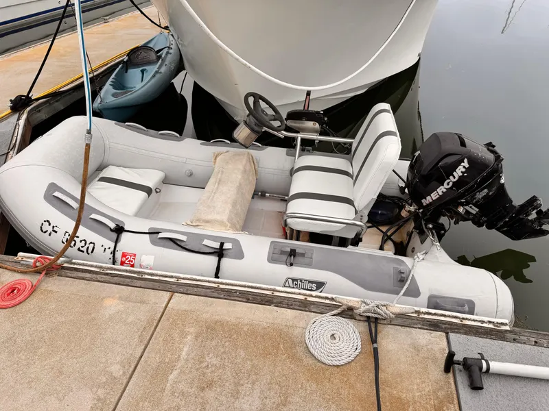 Inflatable boat with Mercury motor docked beside Overseas PT52 Cockpit Motoryacht, 1988 model.