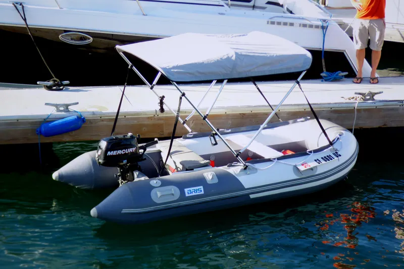 Inflatable boat with Mercury motor docked beside Carver 3607 Aft Cabin Motor Yacht.