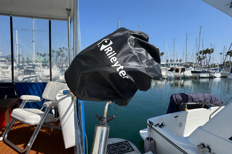 1985 Carver 3607 Aft Cabin Motor Yacht docked, featuring covered equipment and marina view.