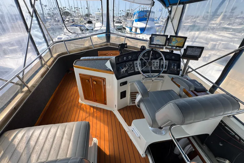 1985 Carver 3607 Aft Cabin Motor Yacht helm with navigation equipment and seating.