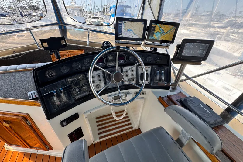 1985 Carver 3607 Aft Cabin Motor Yacht helm with navigation equipment and steering wheel.