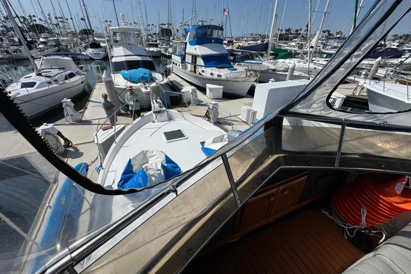 1985 Carver 3607 Aft Cabin Motor Yacht docked in a busy marina.