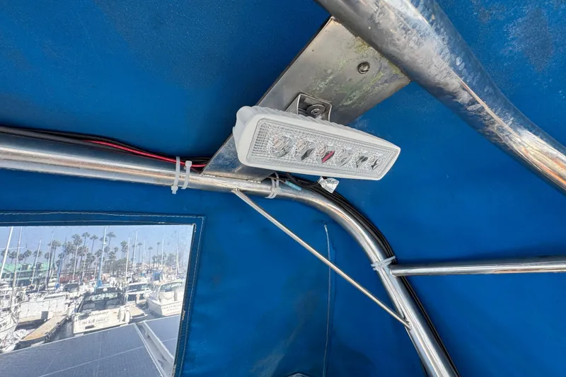 1985 Carver 3607 Aft Cabin Motor Yacht interior with light fixture and marina view.