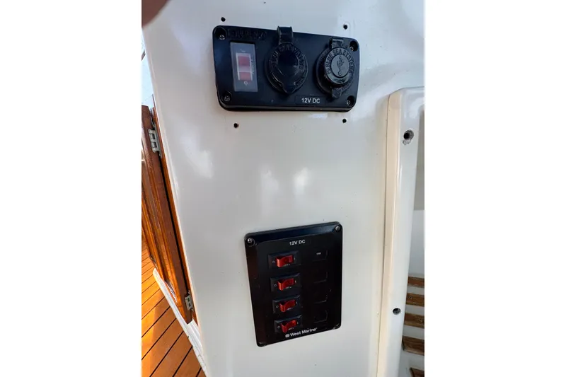 1985 Carver 3607 Aft Cabin Motor Yacht 12V DC panel with switches and outlets.