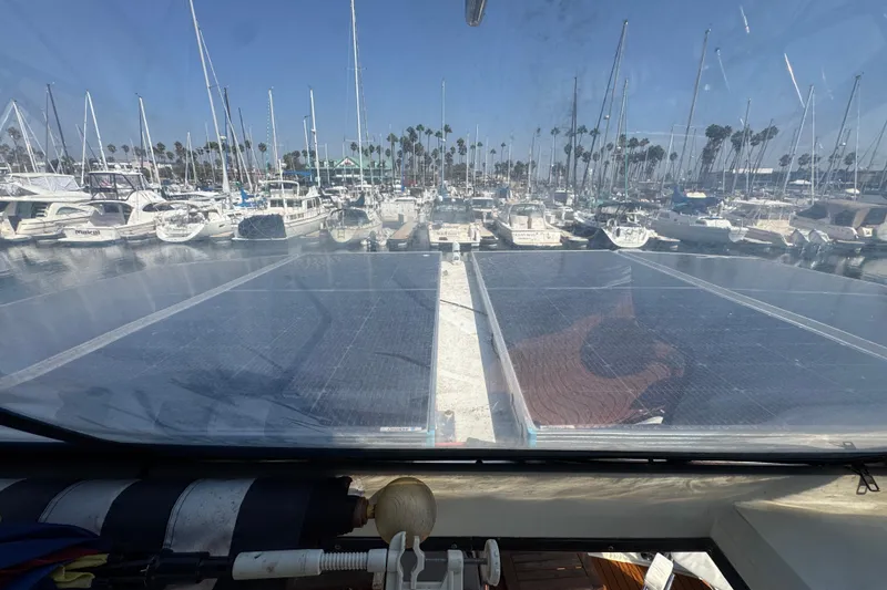 1985 Carver 3607 Aft Cabin Motor Yacht with solar panels in a marina setting.