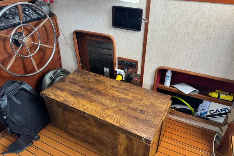 1985 Carver 3607 Aft Cabin Motor Yacht interior with helm, wooden storage, and equipment.