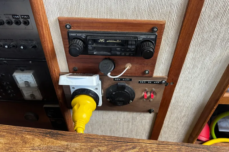 Control panel of a 1985 Carver 3607 Aft Cabin Motor Yacht with radio and power connections.