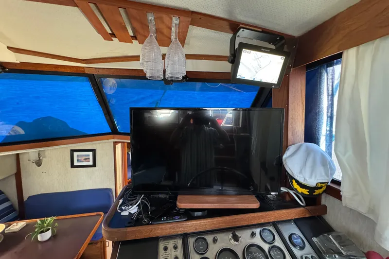 Interior of 1985 Carver 3607 Aft Cabin Motor Yacht with TV and navigation equipment.