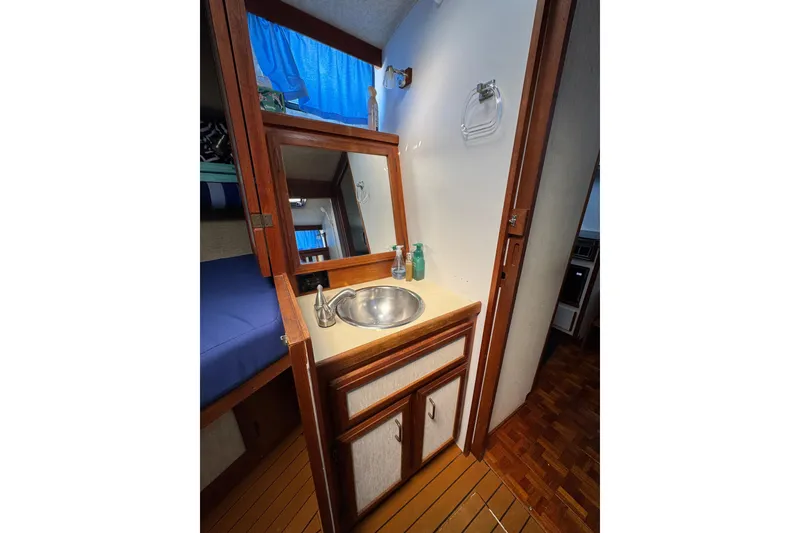 1985 Carver 3607 Aft Cabin Motor Yacht interior with sink and mirror.