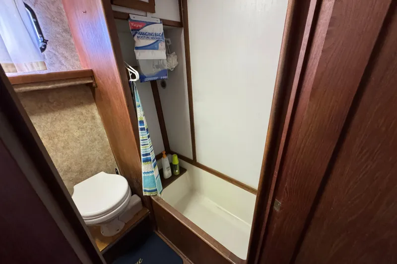 1985 Carver 3607 Aft Cabin Motor Yacht bathroom with toilet and shower.
