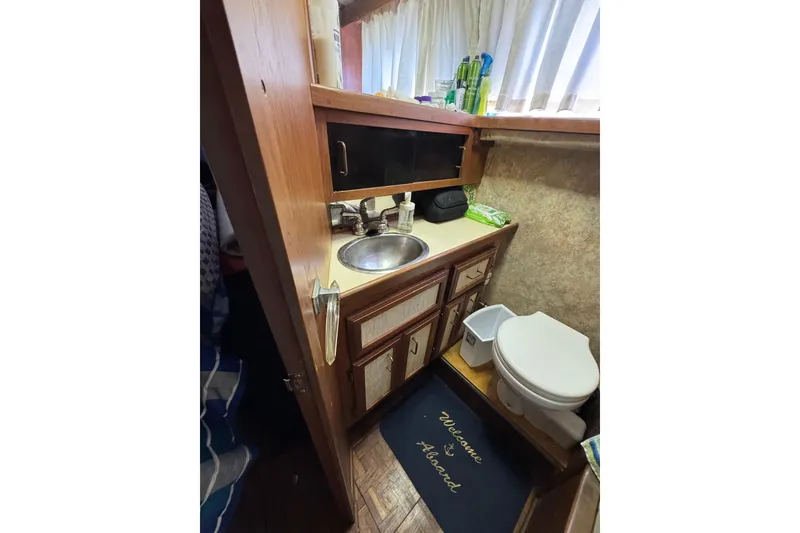 1985 Carver 3607 Aft Cabin Motor Yacht bathroom with sink and toilet.
