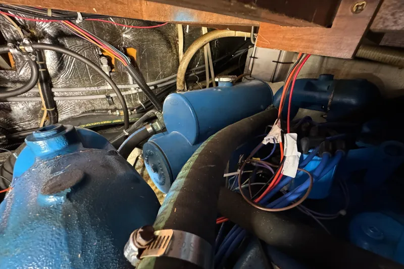 Engine room of 1985 Carver 3607 Aft Cabin Motor Yacht with blue components and wiring.