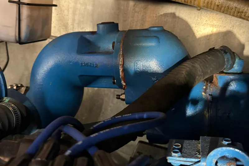 Engine component of 1985 Carver 3607 Aft Cabin Motor Yacht, featuring blue piping and hoses.