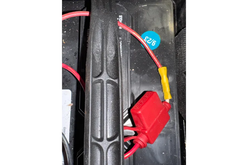 Battery wiring in a 1985 Carver 3607 Aft Cabin Motor Yacht, featuring red and yellow connectors.