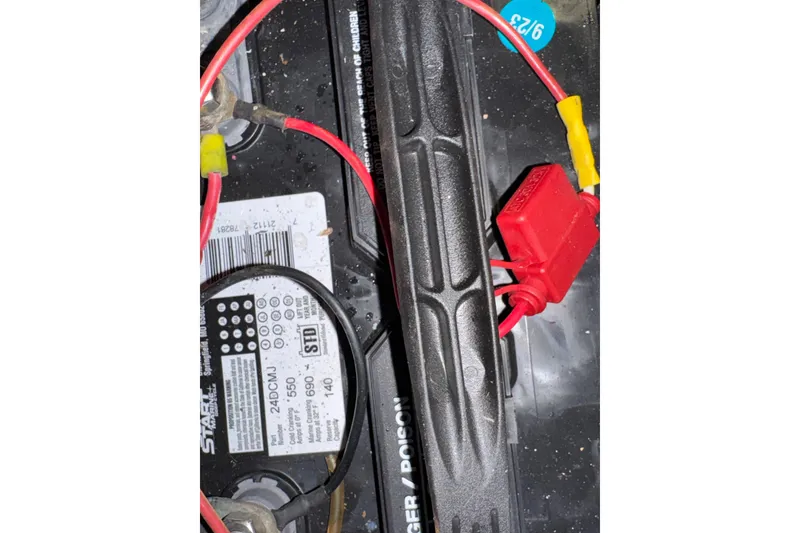 Battery setup in 1985 Carver 3607 Aft Cabin Motor Yacht with red and black cables.