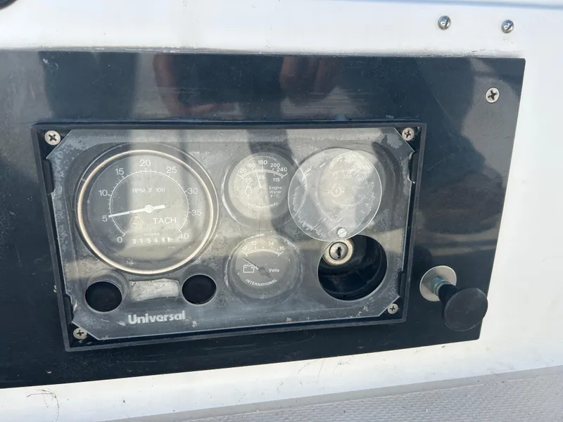 Control panel of a 1981 Catalina 30 sailboat with tachometer and gauges.
