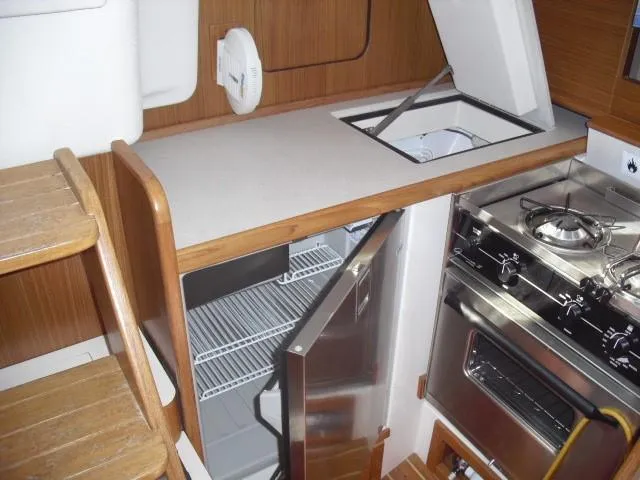 Front loading SS refrigerator (Indel) w/top loading freezer (Frigobart)