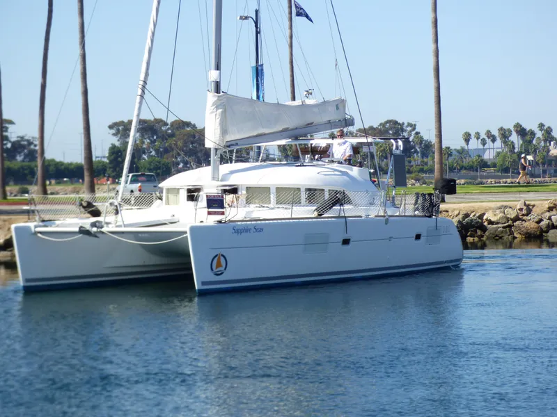 2015 Lagoon 380 catamaran docked in a serene marina setting.