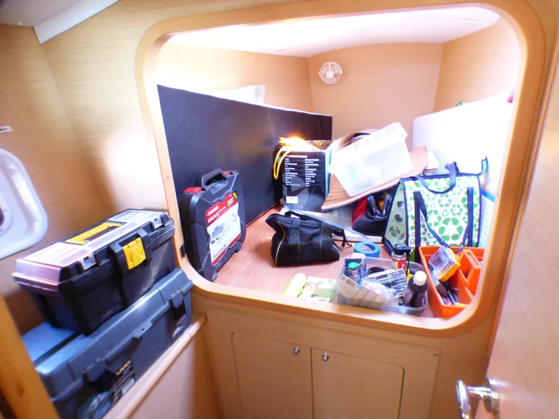 Interior storage area of a 2015 Lagoon 380 catamaran with various tools and supplies.