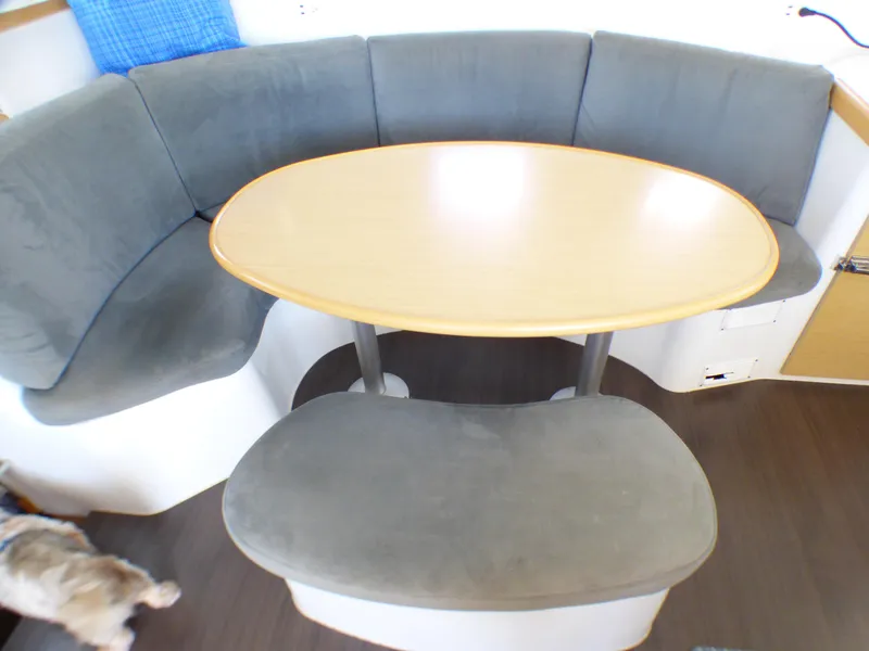 2015 Lagoon 380 interior with curved seating and oval table.