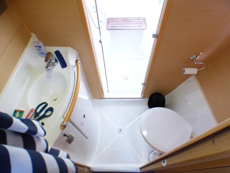 Compact bathroom in 2015 Lagoon 380 catamaran with shower, sink, and toilet.
