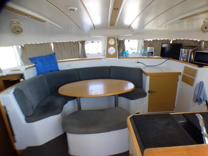 Interior of 2015 Lagoon 380 catamaran with cozy seating and dining area.