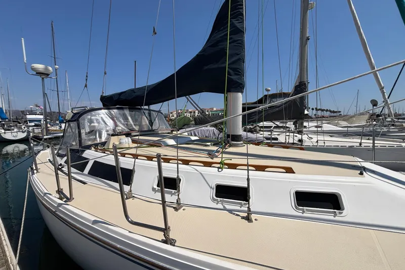 1987 Catalina 34 sailboat docked in marina, featuring sleek design and rigging.