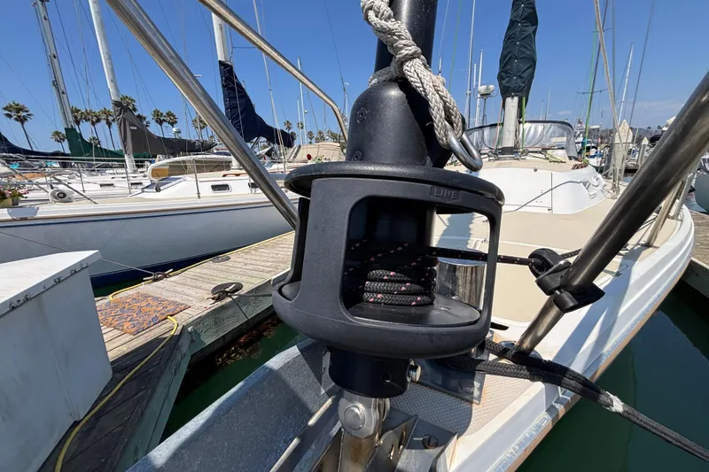 1987 Catalina 34 sailboat docked at marina, featuring rigging and deck details.