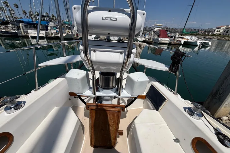 1987 Catalina 34 sailboat cockpit with NavPod, docked in a marina.