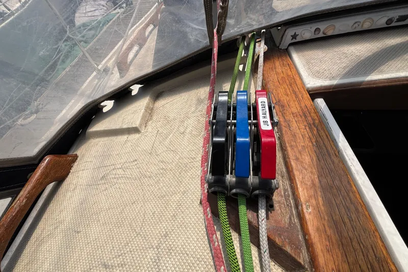 Close-up of 1987 Catalina 34 sailboat deck with rope clutches and lines.