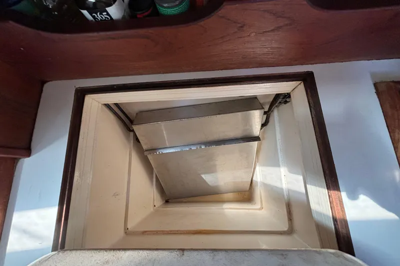 Interior view of a 1987 Catalina 34 sailboat, featuring a storage compartment.