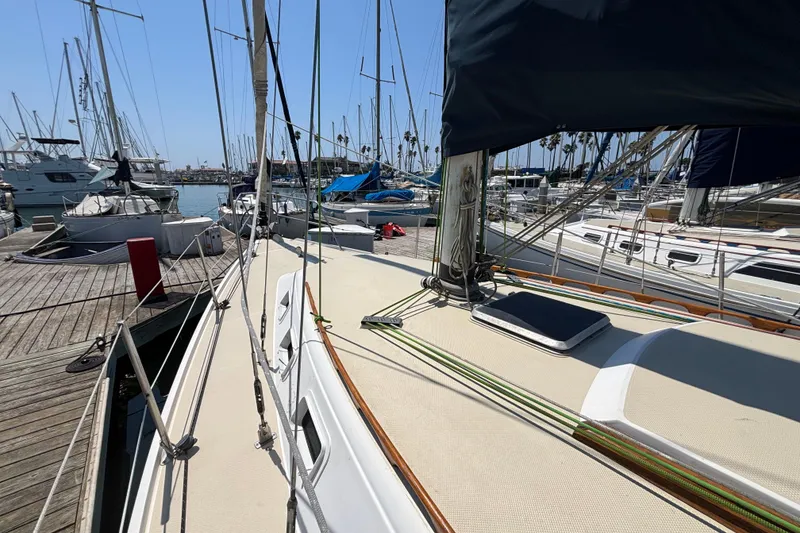 1987 Catalina 34 sailboat docked at marina, surrounded by other boats.