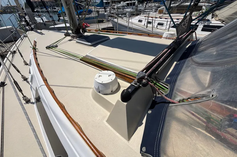 1987 Catalina 34 sailboat deck with rigging and marina background.