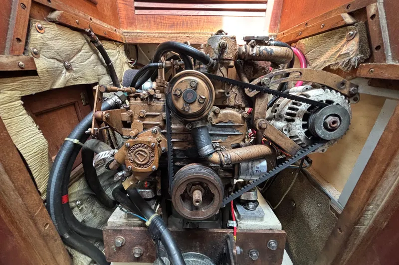 Engine of a 1987 Catalina 34 sailboat, showing belts and components.