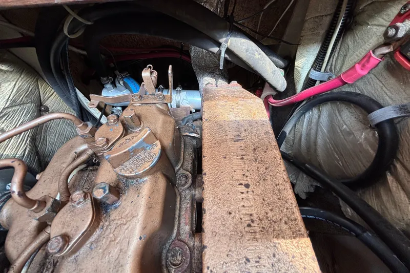 Engine compartment of a 1987 Catalina 34 sailboat, showing mechanical components and wiring.