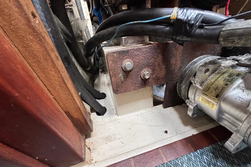 Engine compartment of a 1987 Catalina 34 sailboat, showing mechanical components and wiring.
