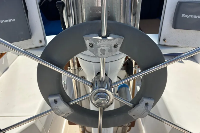 Steering wheel of a 1987 Catalina 34 sailboat with Raymarine equipment.