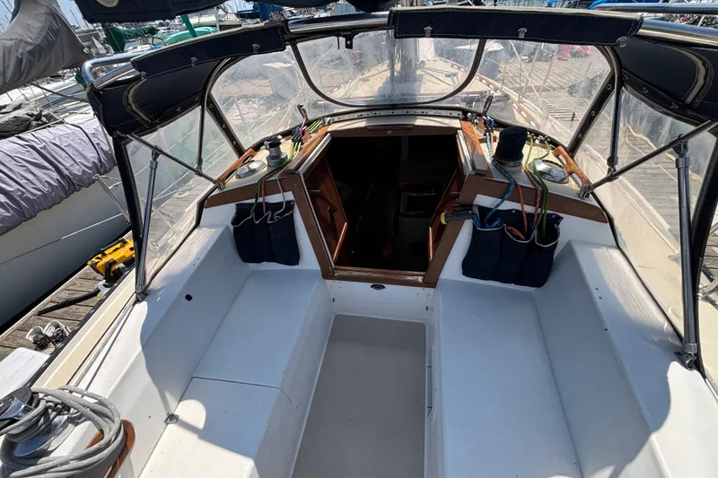 1987 Catalina 34 sailboat cockpit with open cabin entrance and visible rigging.