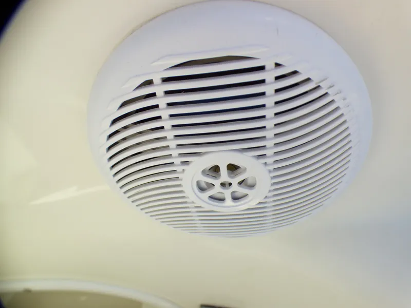 Boat speaker on 2003 Sea Ray 260 Sundancer, white grille, close-up view.