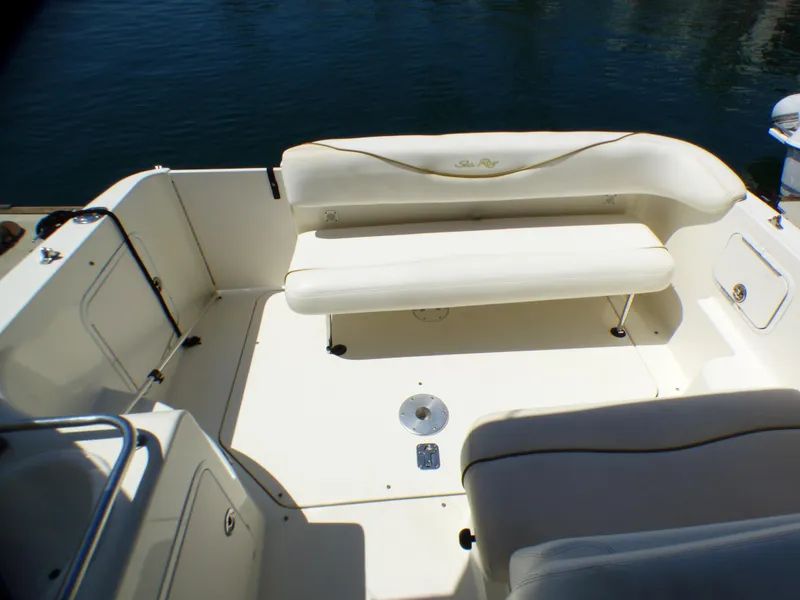 2003 Sea Ray 260 Sundancer boat interior with white seating and open deck area.