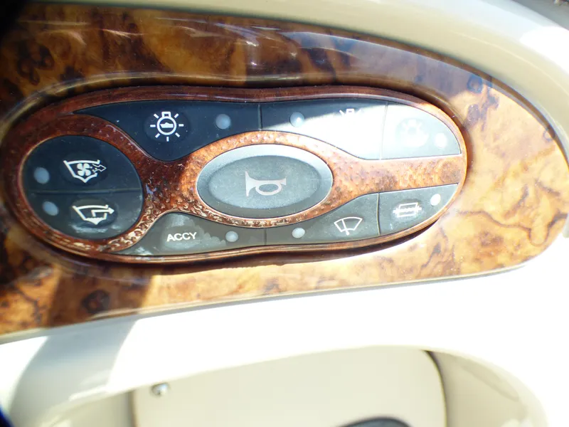 Control panel of 2003 Sea Ray 260 Sundancer boat with wood finish.