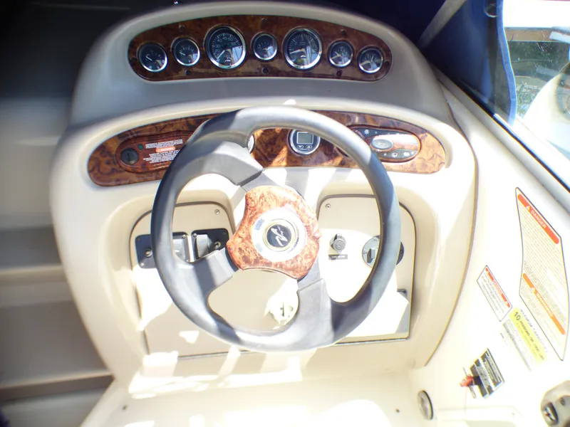 Steering wheel and dashboard of 2003 Sea Ray 260 Sundancer boat.